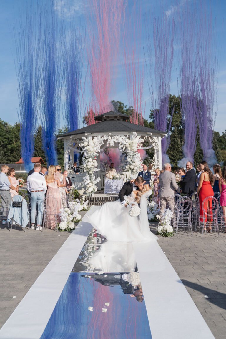 Pierwszy pocałunek Pary Młodej wśród kolorowych dymów – magiczny moment